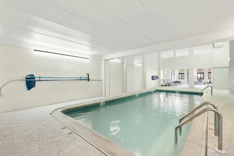 Modern indoor pool area at a hotel in Tinton Falls, NJ, USA, offering a serene swimming experience.